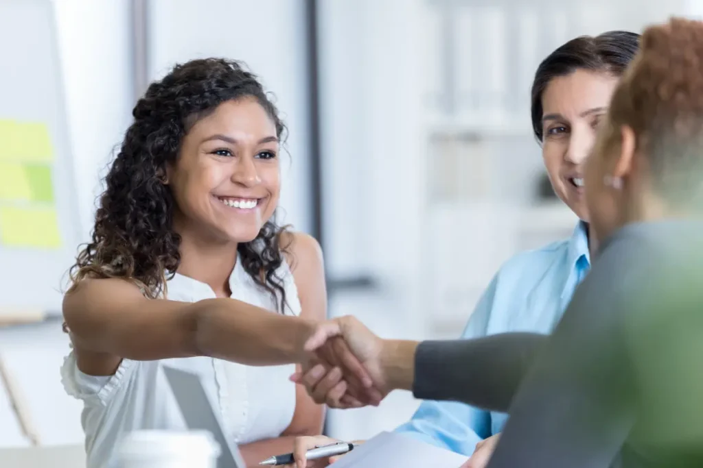 Two colleagues shaking hand. 