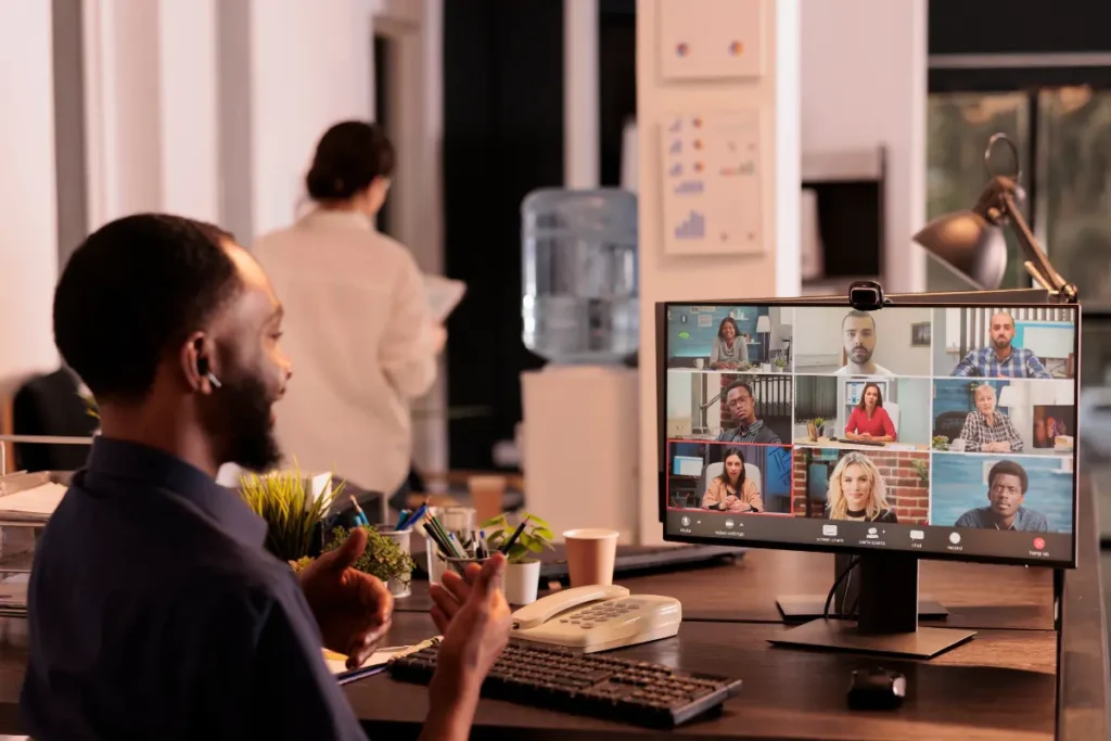 A smiling man on a virtual meeting. 