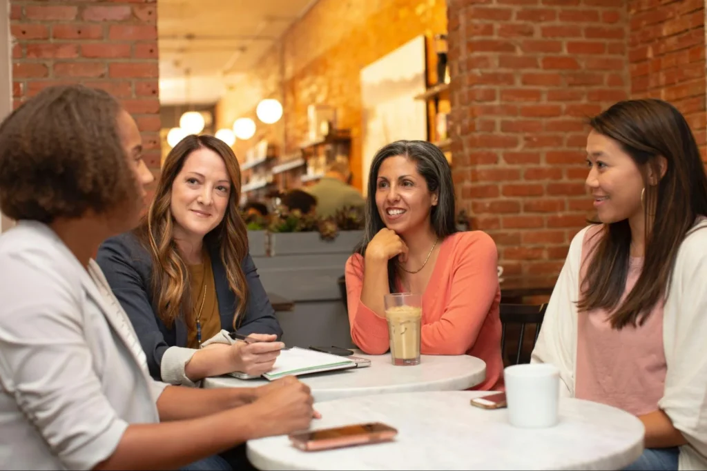 Group of colleagues sitting around a table having a discussion.