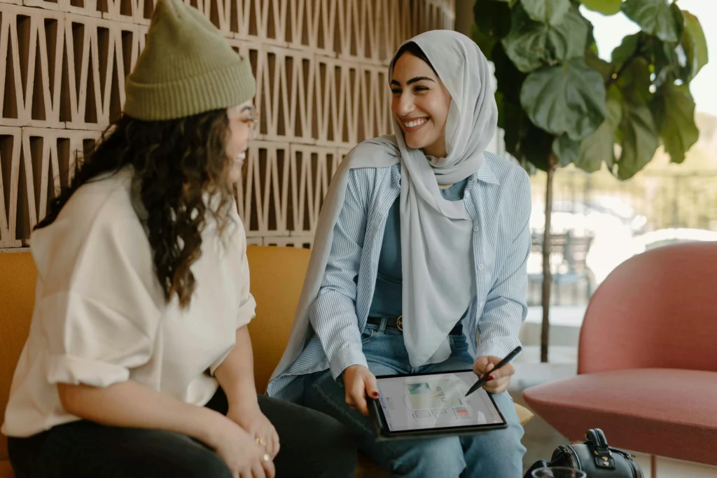 Two women smiling while conversing outside