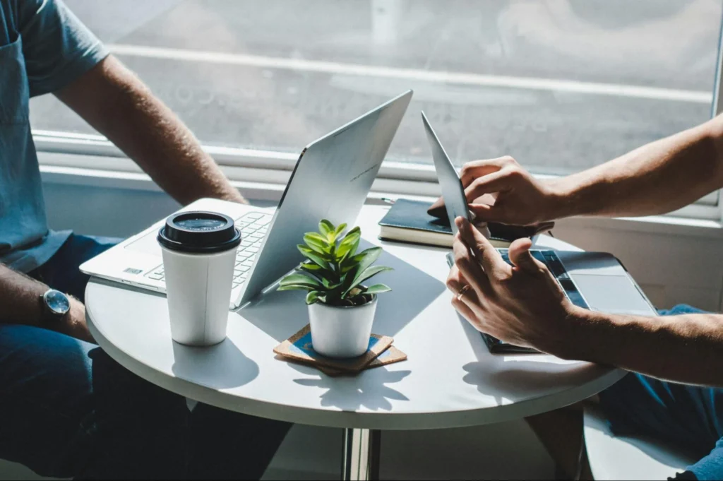 Two men working on their laptops
