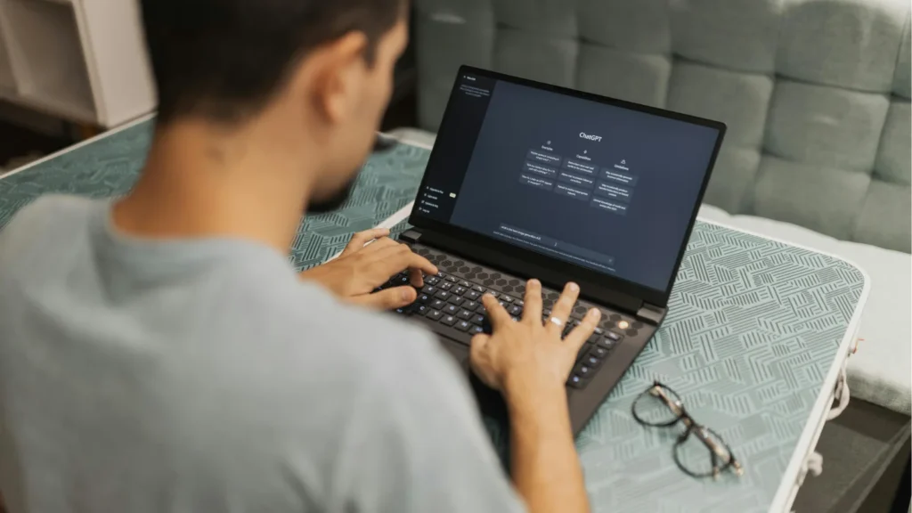 A man is using a laptop computer on a table