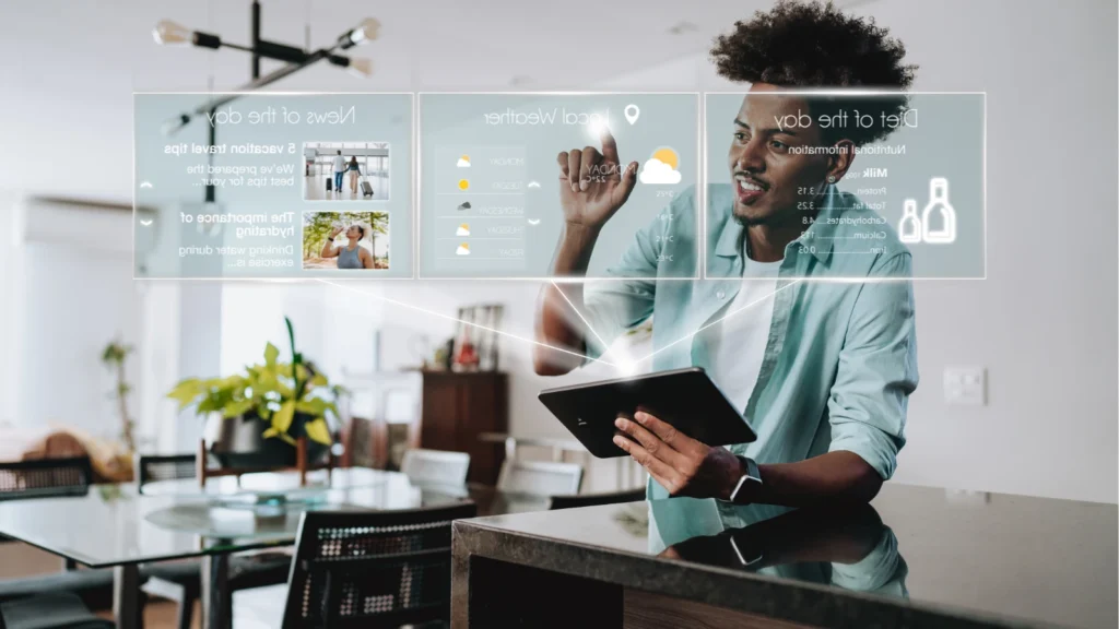 A man holding a tablet interacts with glowing futuristic digital interface displays hovering in his home living space.