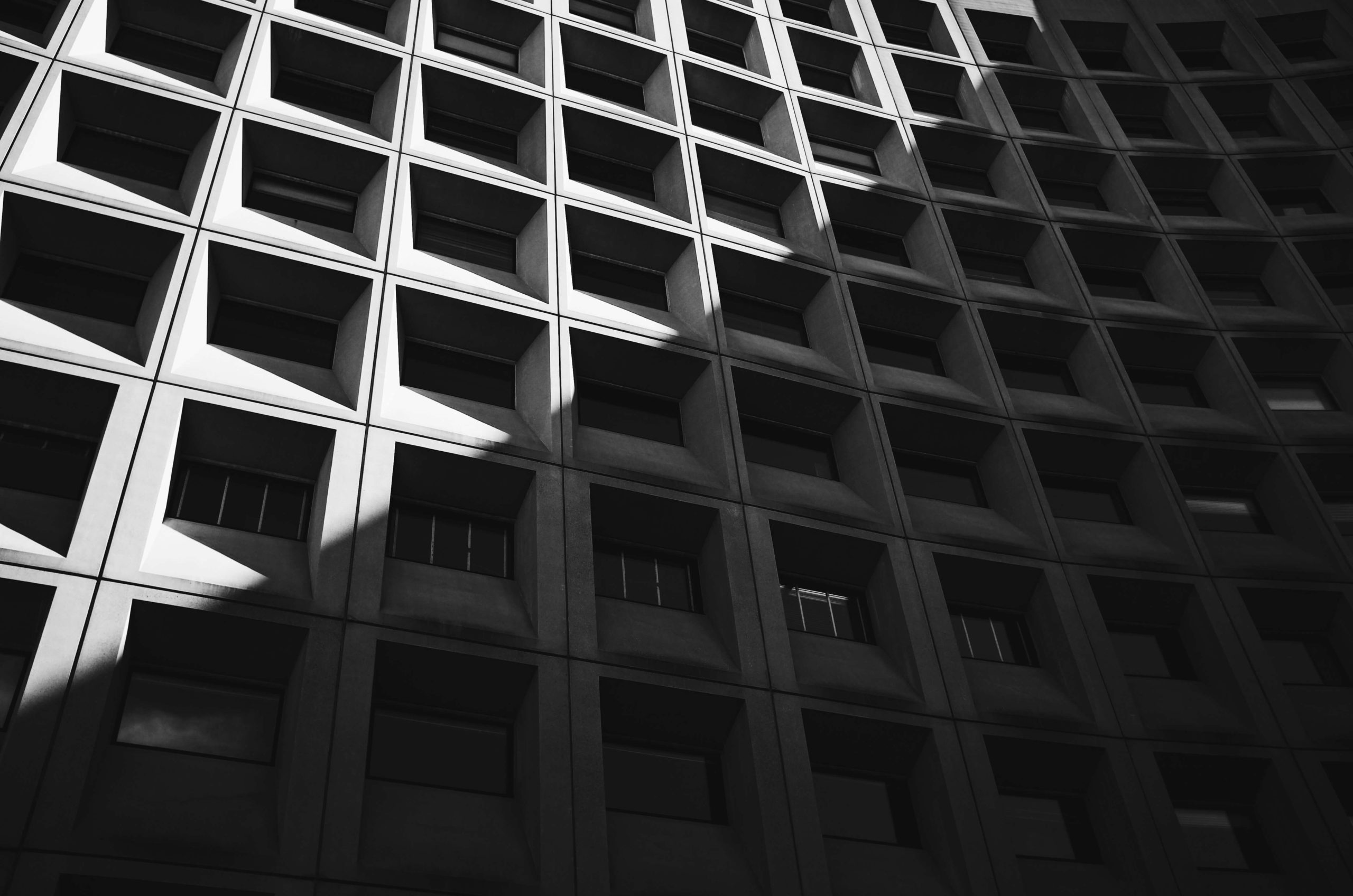 Shadowy building with grid architecture.