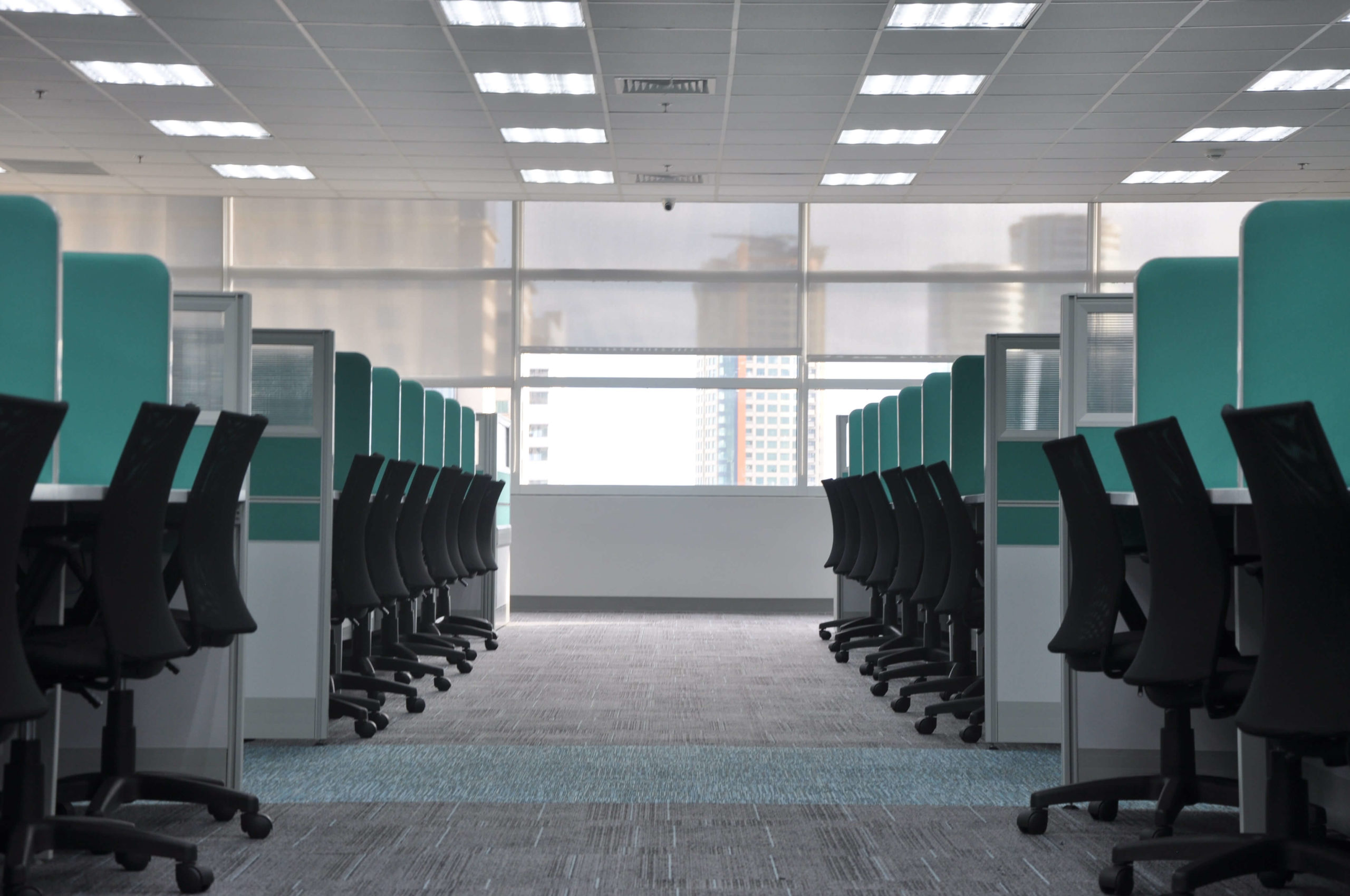 Empty rows of office cubicles.