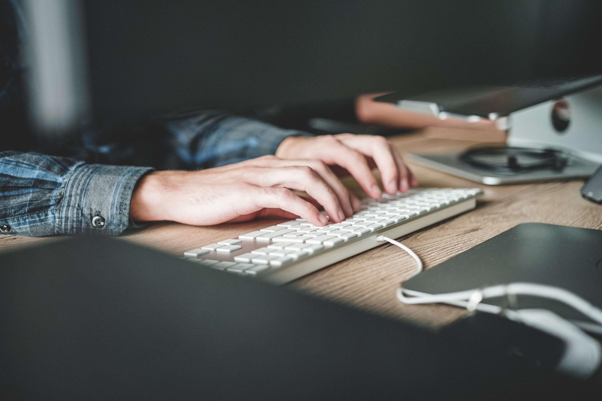 close up image of hands typing on a keyboard