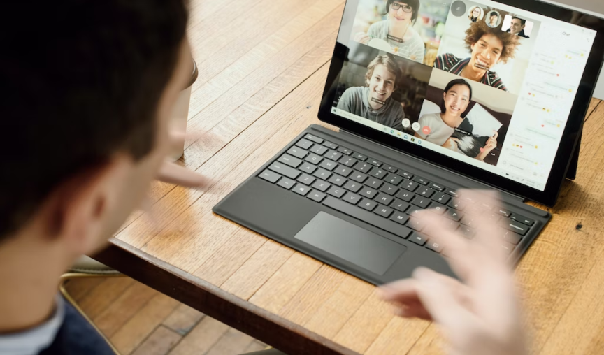 employee in a virtual meeting talking to his colleagues via a tablet