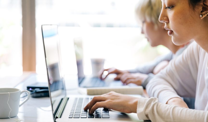 employee typing away on her laptop