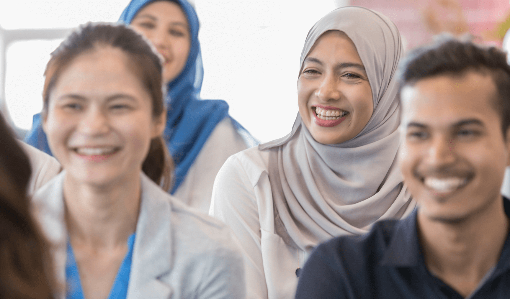 employees smiling in a room together