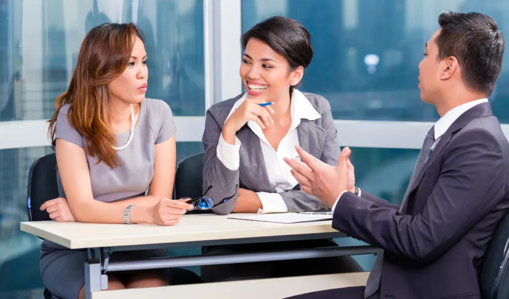 two colleagues interviewing an employee