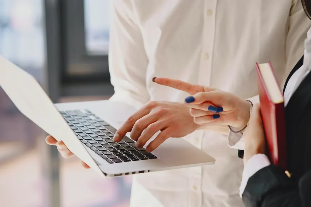 colleagues discussing about something shown on a laptop