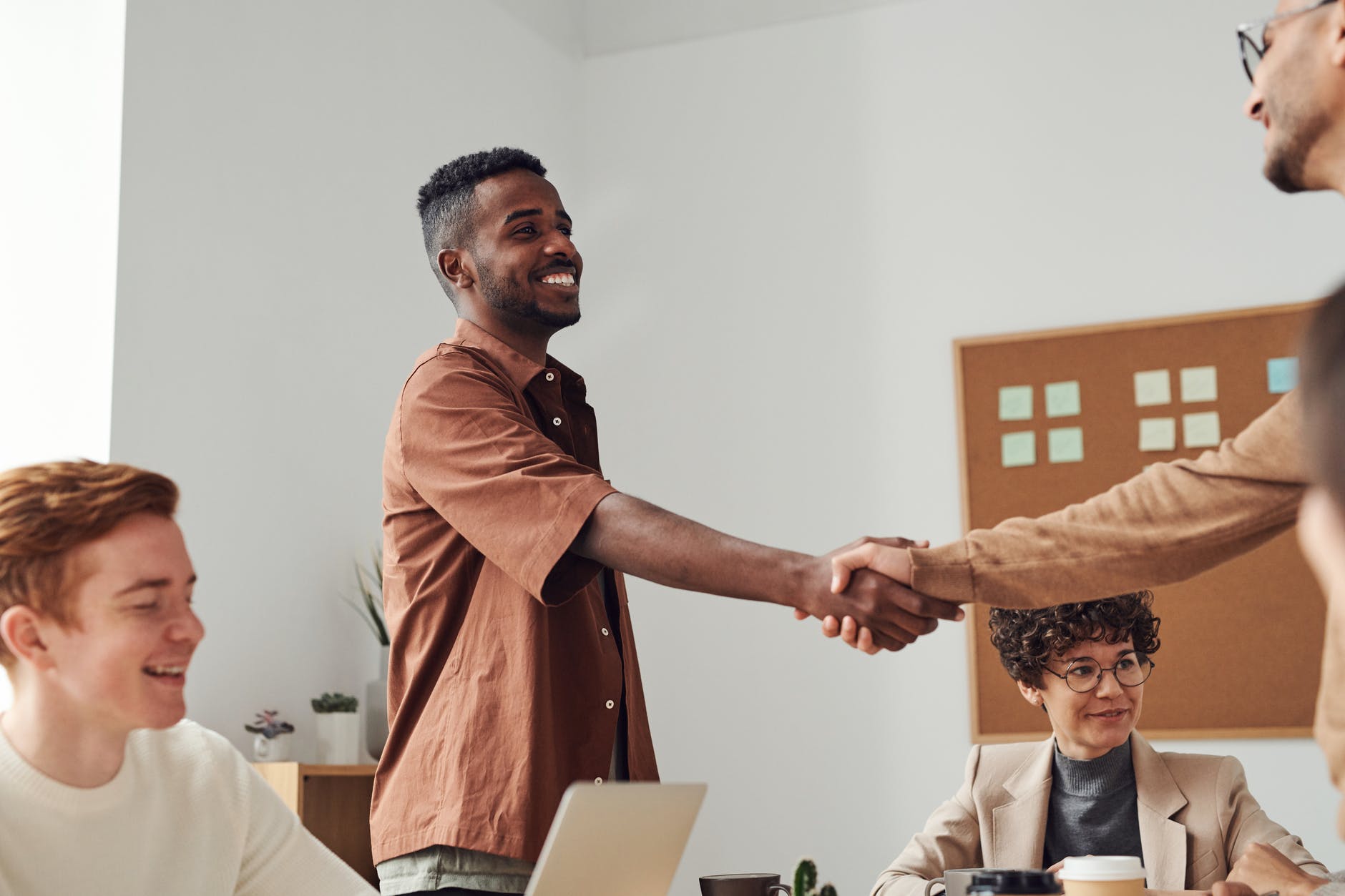 two workers shake hands over employment legislation