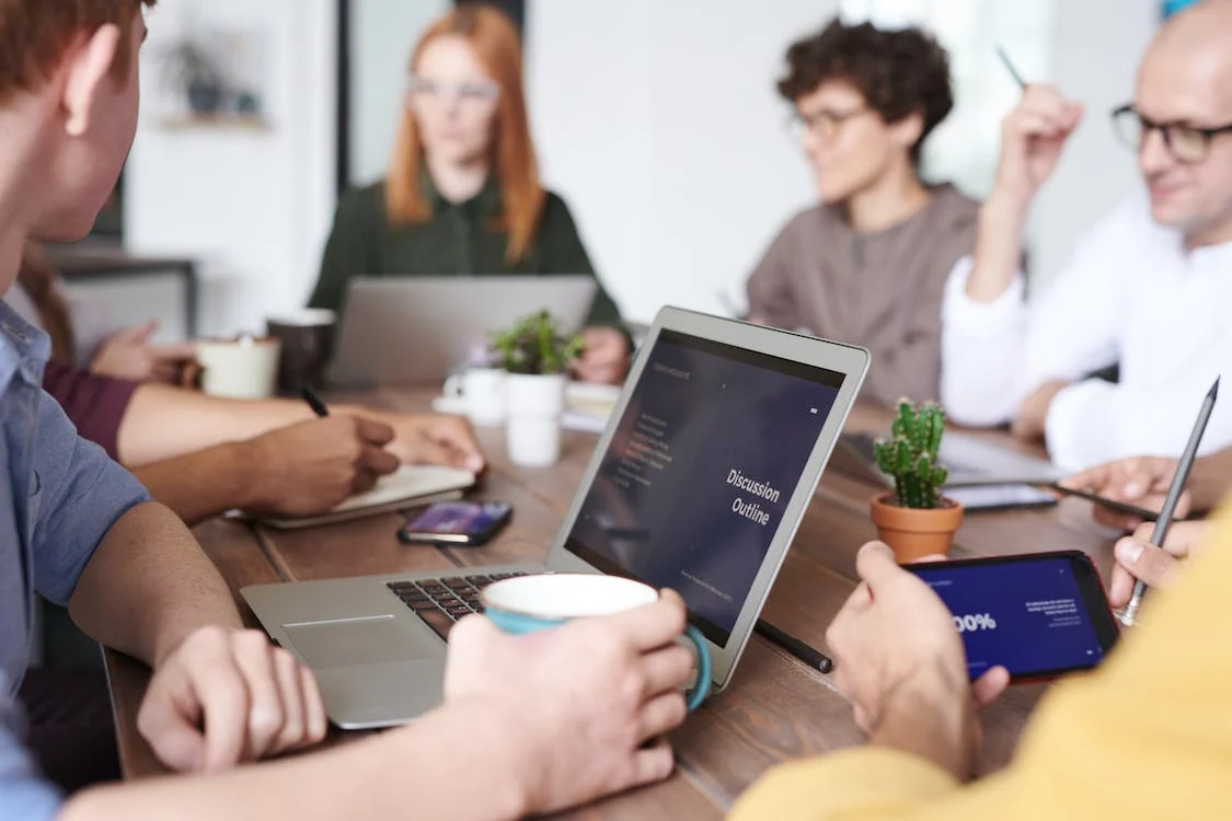 employees in a meeting room discussing