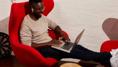 image of a man sitting down on his laptop - distributed workforce