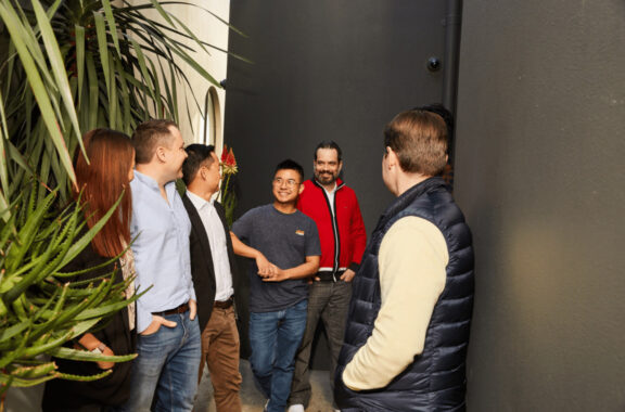 a group of colleagues laughing at a joke
