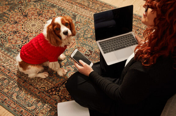 Woman working from home with her dog.