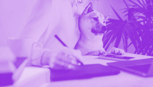 Purple wash close up shot of a feminine figure on their laptop and dog on their lap