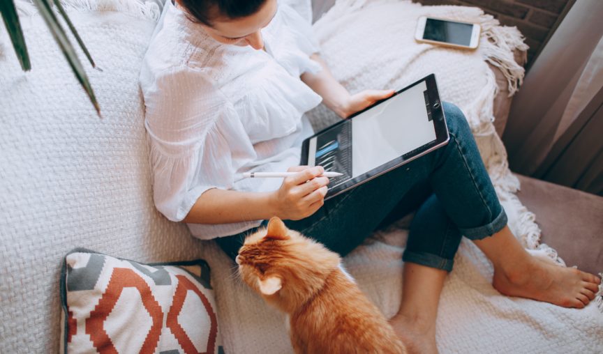 A woman working remotely with her pet