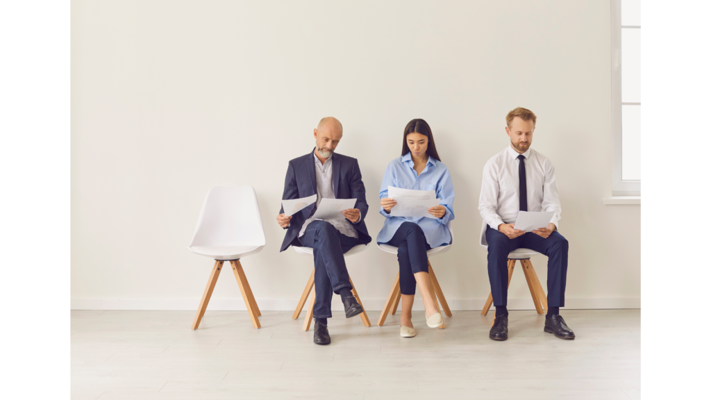 Office workers sitting on chairs while holding papers