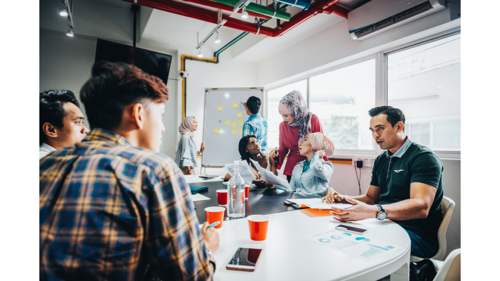 A team working at a round table on a project