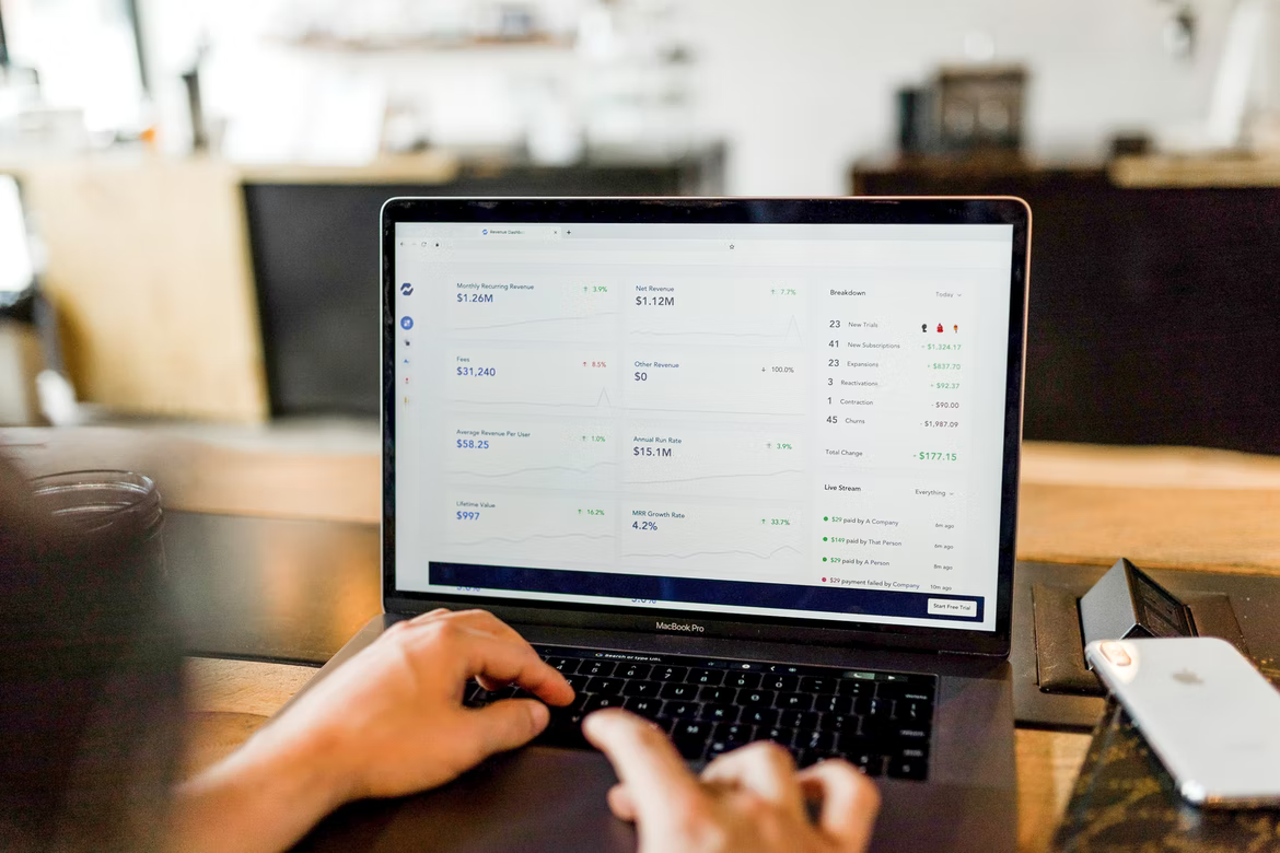 Employee using laptop to view a dashboard on data analysis