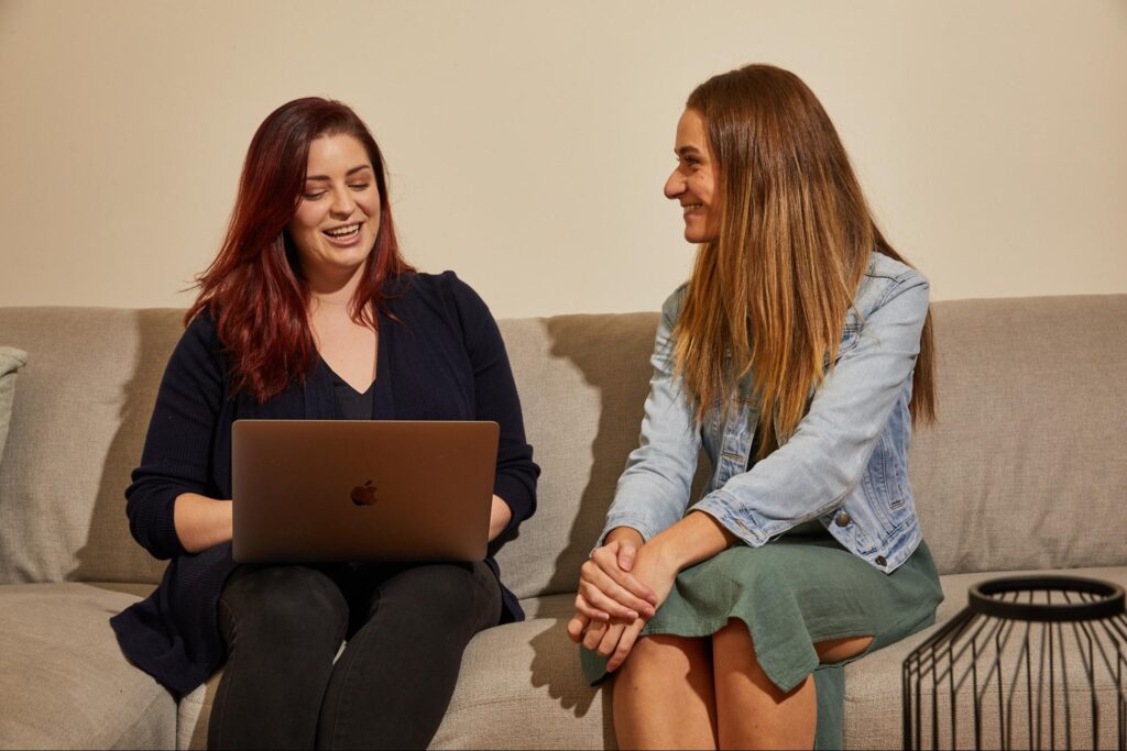 Two women chatting about work