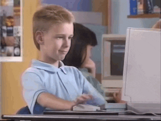 Boy sits at computer, smiling and nodding, before giving the camera a thumbs up