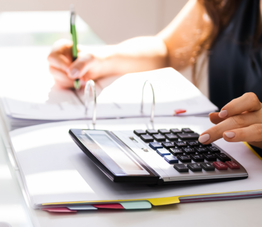 woman using the calculator at work