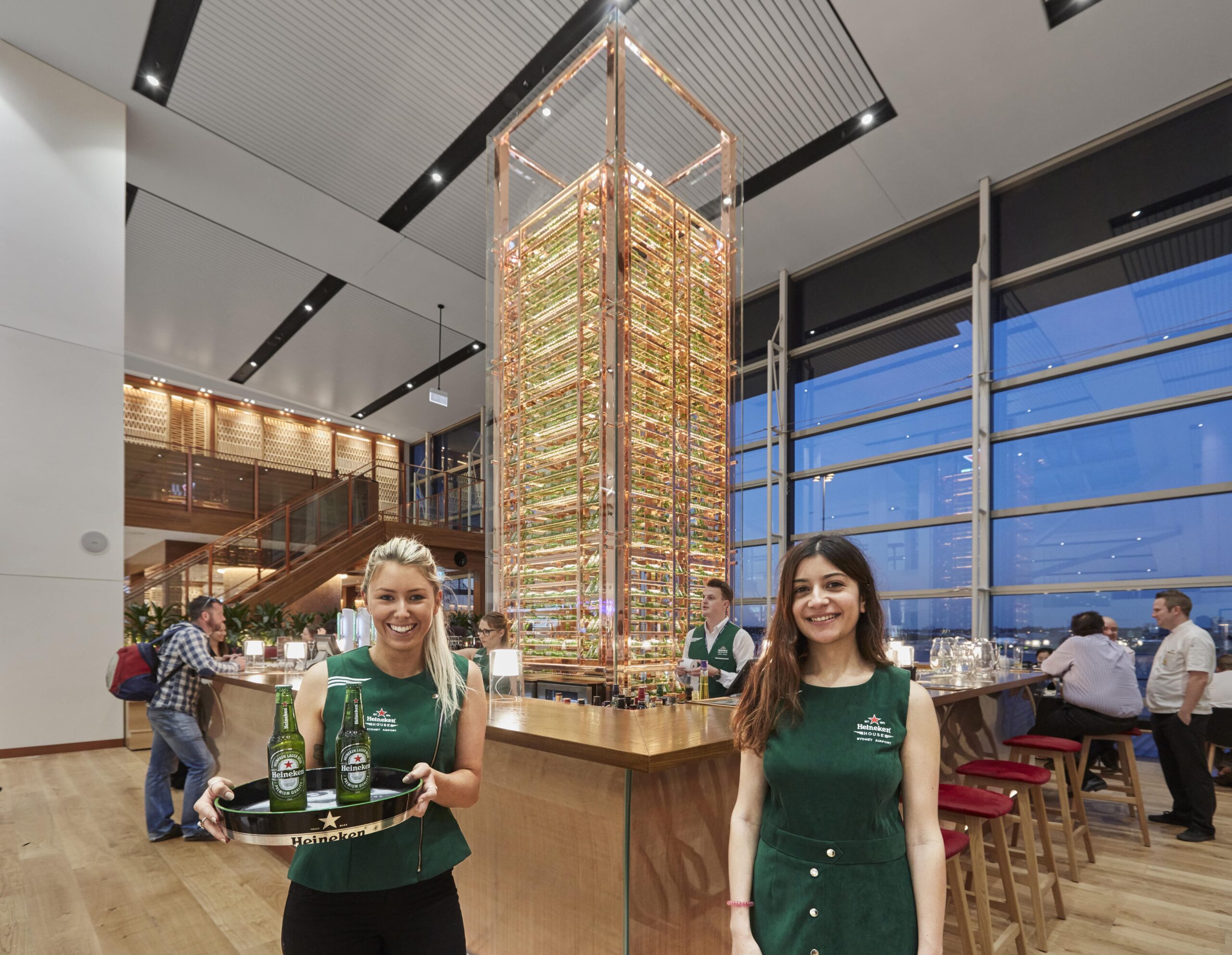 Two female staff members ready to greet customers at Heineken House.