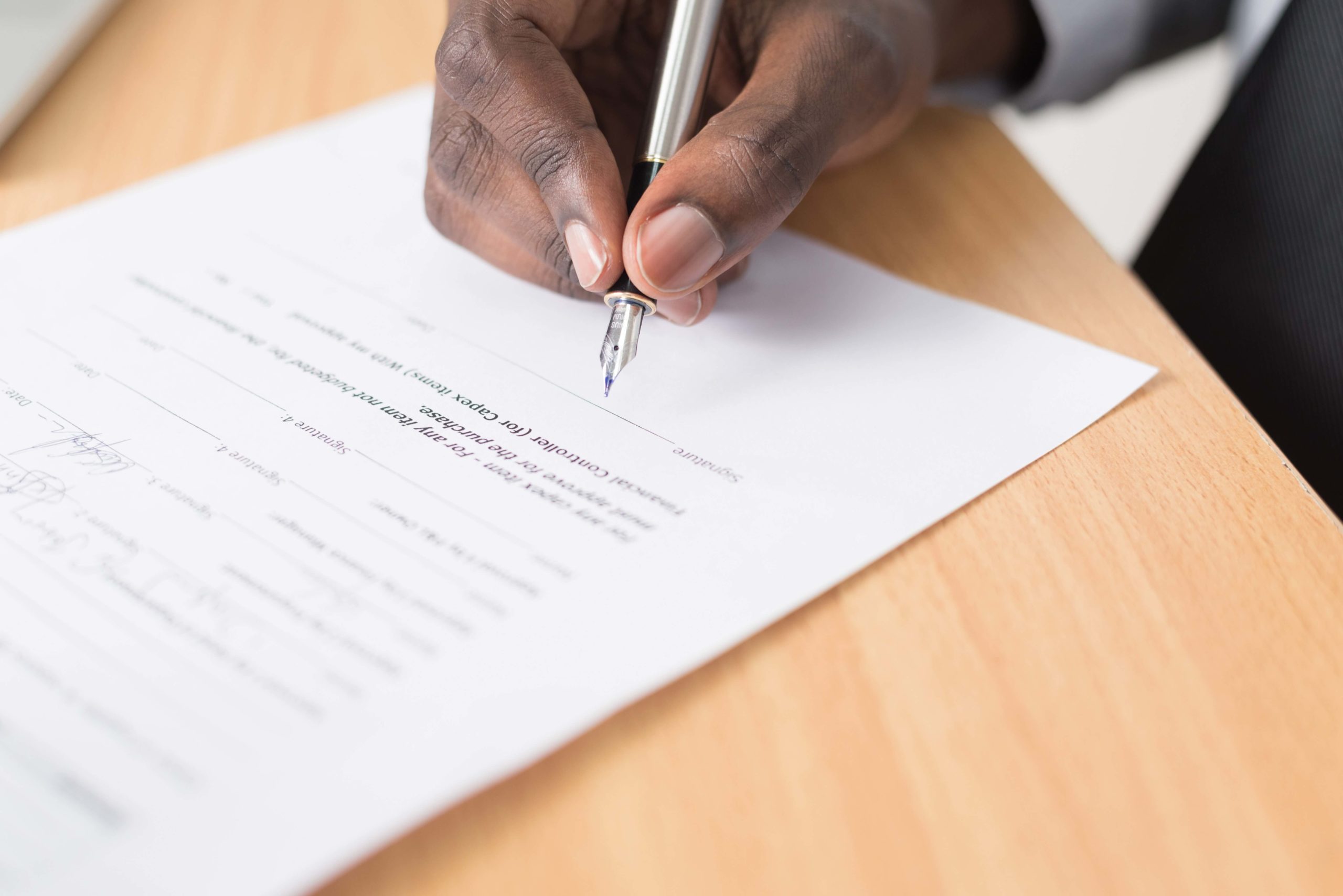 man signing the contract