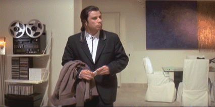 John Travolta alone in a room, looking around confused