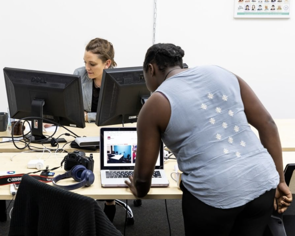Two people at a coworking space, both at laptops