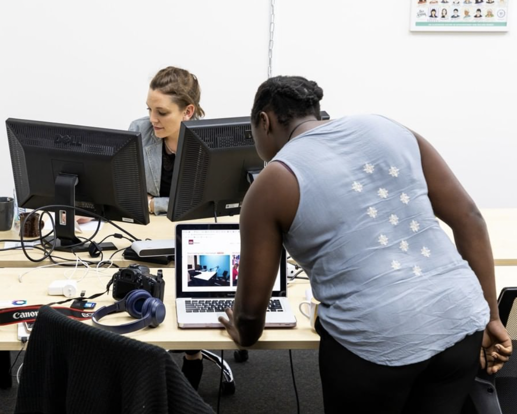 Two people at a coworking space, both at laptops