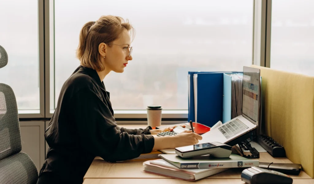 Woman in her office table focused on desk work