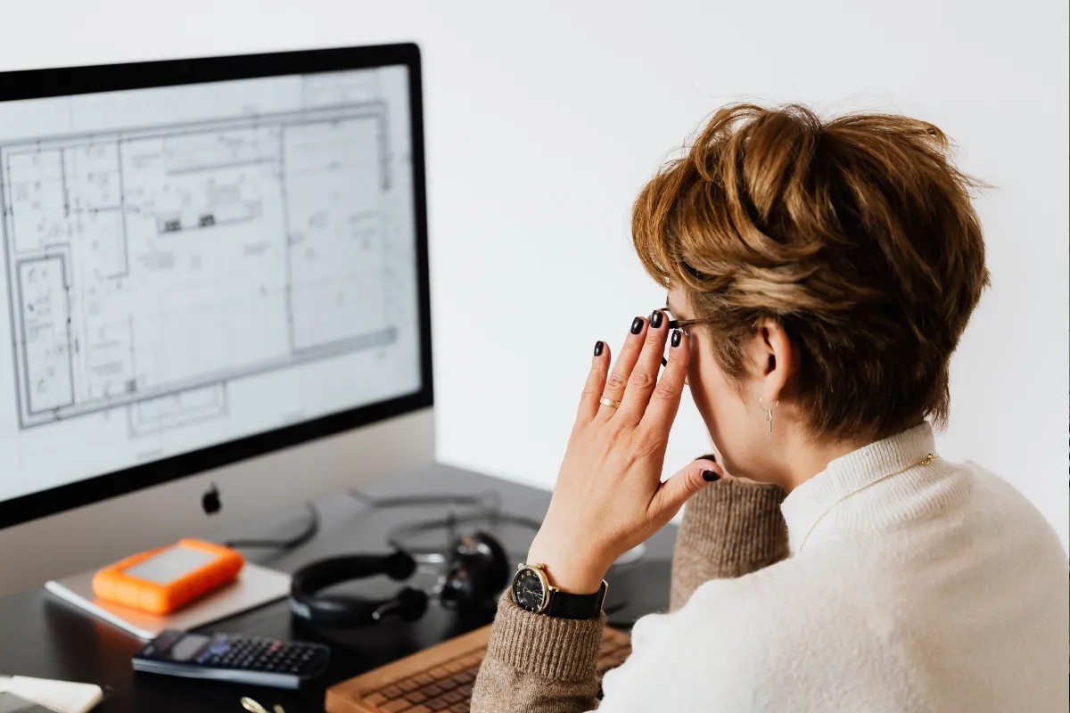 Woman reviewing a floor plan on the computer
