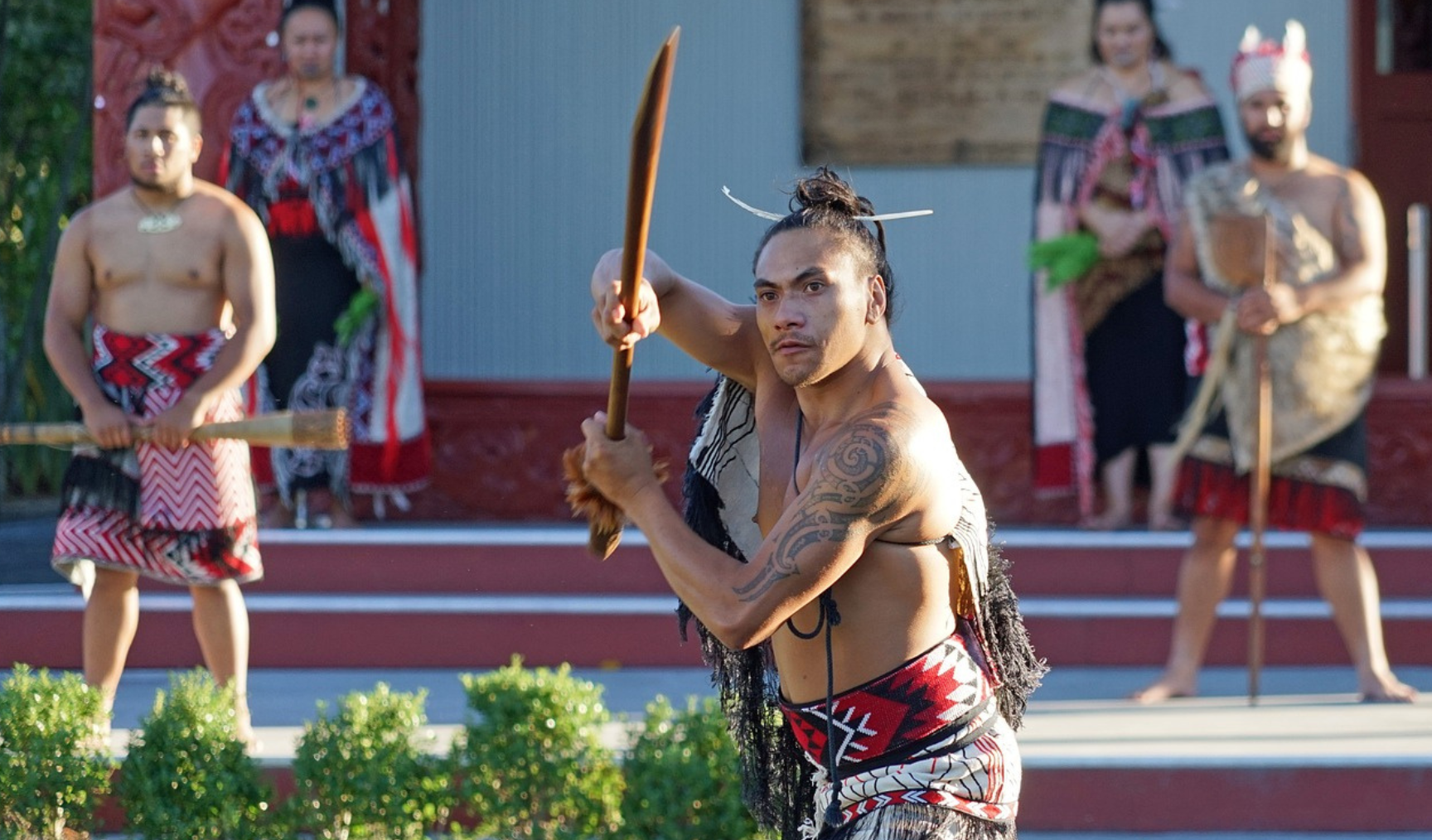 A Maori warrior in front of a marae