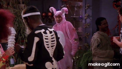 Chandler from Friends walks through a halloween party dressed as the easter bunny