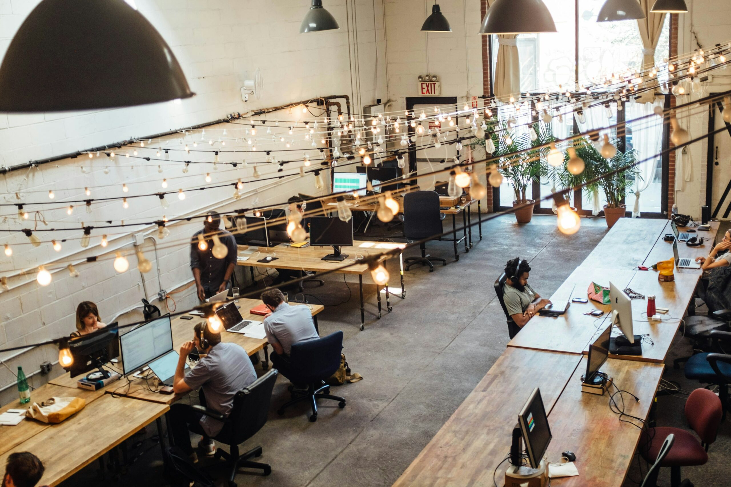 Large open office, with people sitting at laptops
