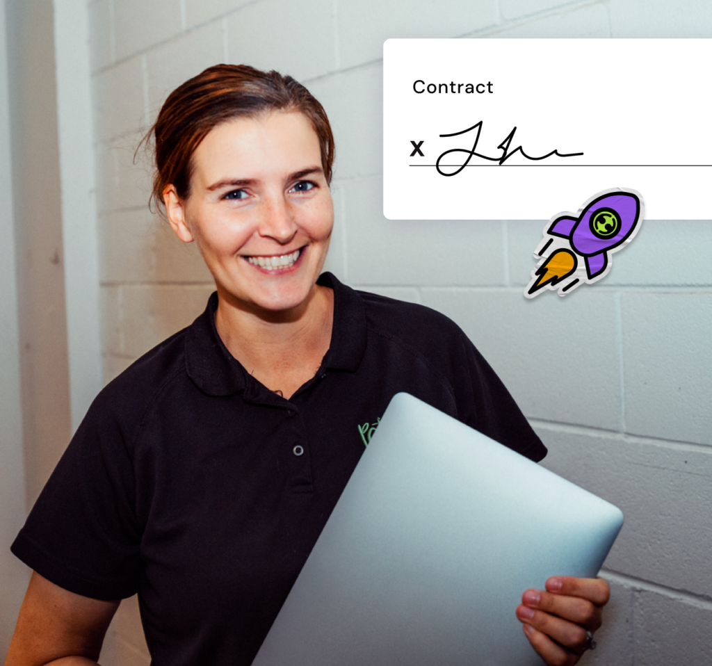 Smiling woman in a black polo holding a laptop, with a contract signature and rocket icon overlay.