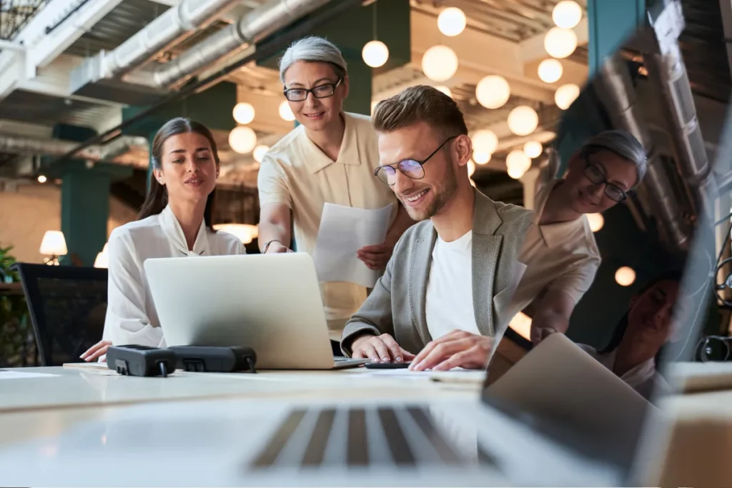 Three colleagues collaborating on their work