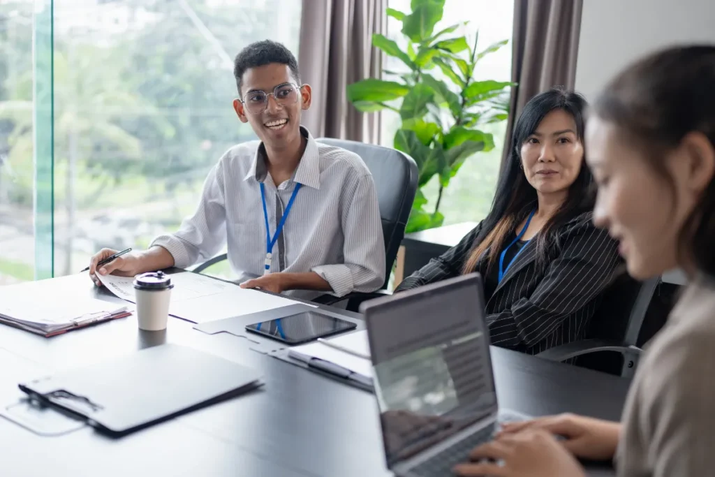 Three colleagues sharing a well-lit coworking space