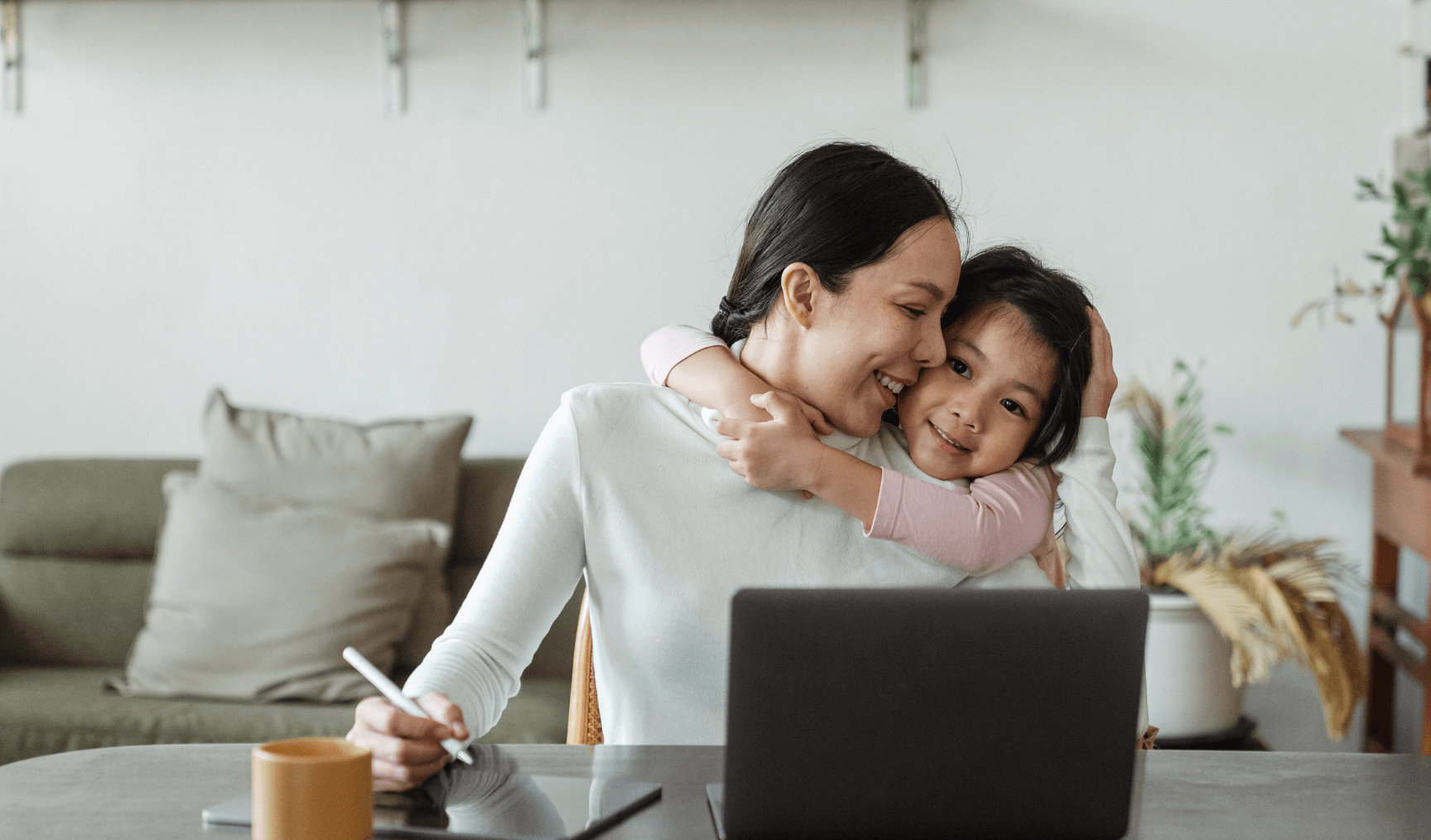 a mother working from home showing affection to her daughter