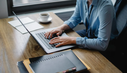 image of an employee at her desk looking through some papers