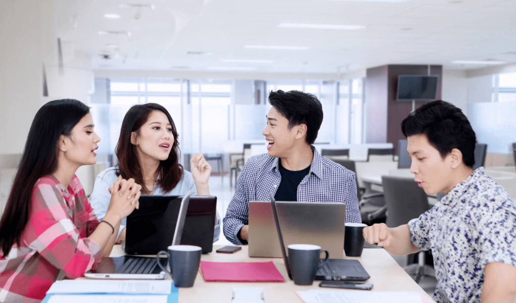 a group of colleagues working together on laptops