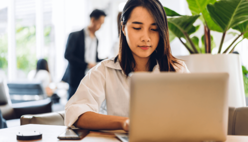 woman typing on her laptop in the office