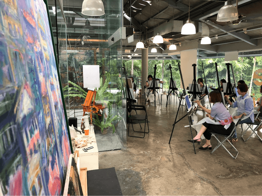 People sitting in an art studio doing art jamming