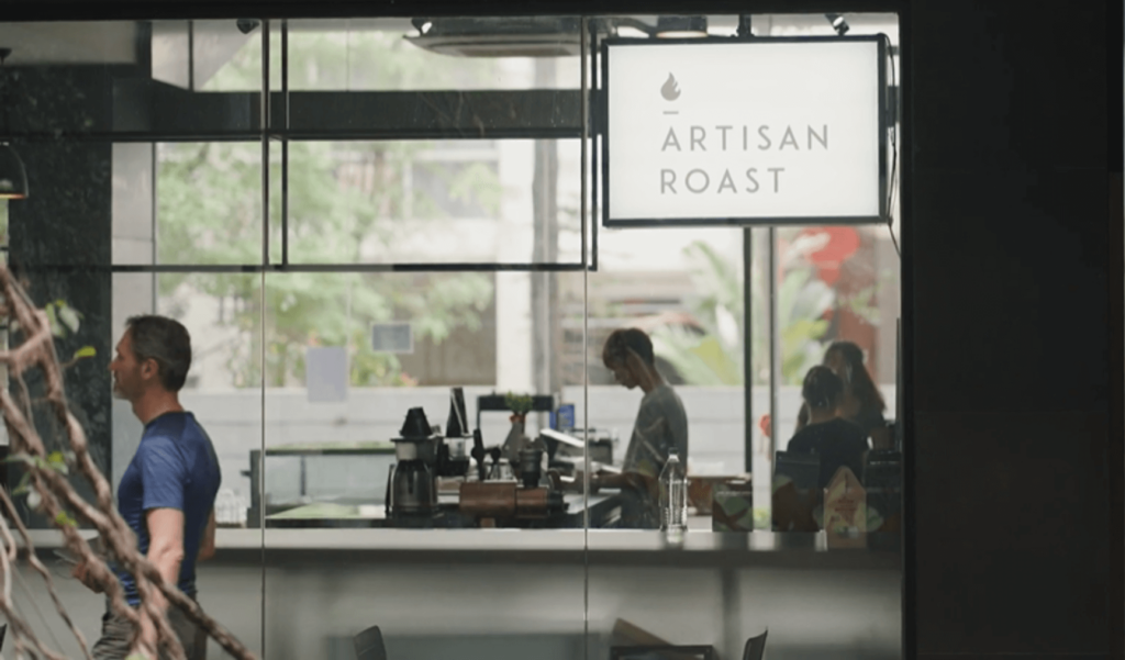 Michael walking past Artisan Roast cafe