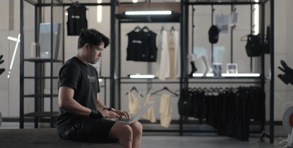Amir working on his laptop in Journey Indoor Cycling Studio