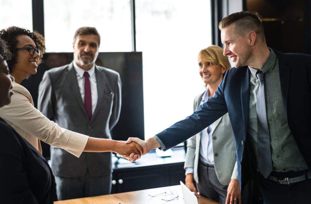 handshake with friendly smiles in the office