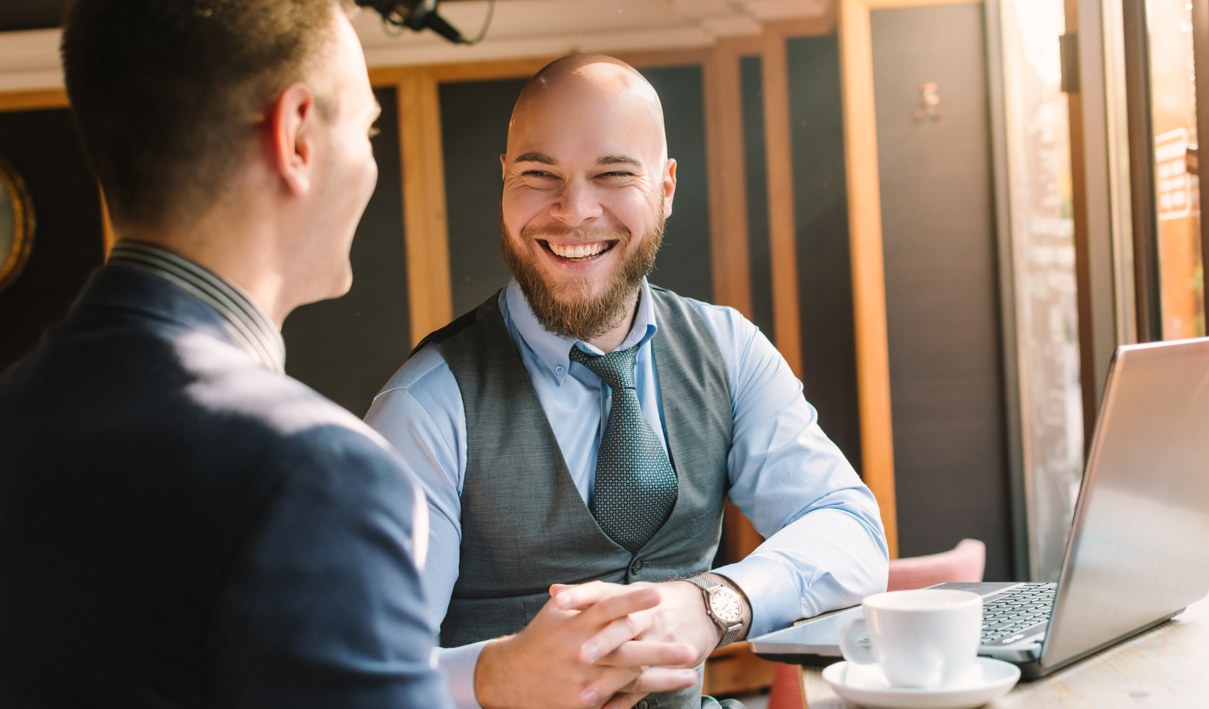 employees having a laugh while chatting together in the office